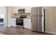 Updated kitchen features stainless steel appliances and granite countertops with white cabinetry at 4417 Roche St, Atlanta, GA 30349