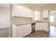 Well-lit kitchen with white cabinets, granite countertops, and stainless steel dishwasher at 4417 Roche St, Atlanta, GA 30349