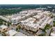 An aerial view of the vibrant mixed-use development featuring apartments, retail, and ample parking at 11715 Dancliff Trce, Alpharetta, GA 30009