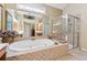 Bright bathroom features a large tub and glass enclosed shower at 11715 Dancliff Trce, Alpharetta, GA 30009