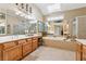 Large bathroom features a soaking tub, glass enclosed shower and neutral tile at 11715 Dancliff Trce, Alpharetta, GA 30009