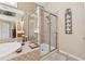 Bathroom with neutral tile, a glass enclosed shower and soaking tub at 11715 Dancliff Trce, Alpharetta, GA 30009