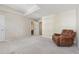 Bright bedroom features neutral walls, plush carpet, an armchair, and leads to an ensuite bathroom at 11715 Dancliff Trce, Alpharetta, GA 30009