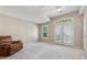 Spacious bedroom with plush carpeting, double doors to balcony, neutral walls, and ample natural light at 11715 Dancliff Trce, Alpharetta, GA 30009