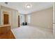 Bright bedroom with plush carpeting, neutral walls, a storage safe, and a window with shutter blinds at 11715 Dancliff Trce, Alpharetta, GA 30009