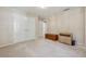 Bedroom featuring plush carpeting, neutral walls, an armoire, and a double door closet with ample storage at 11715 Dancliff Trce, Alpharetta, GA 30009
