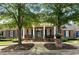 Academy Park Clubhouse featuring brick construction, symmetrical design, and mature landscaping at 11715 Dancliff Trce, Alpharetta, GA 30009