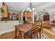 Dining area next to kitchen and living room with hardwood floors and natural light at 11715 Dancliff Trce, Alpharetta, GA 30009