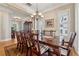 Formal dining room with a large wooden table, chandelier lighting, and decorative accents at 11715 Dancliff Trce, Alpharetta, GA 30009
