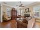 Cozy living room featuring a fireplace, hardwood floors, and comfortable seating arrangements at 11715 Dancliff Trce, Alpharetta, GA 30009