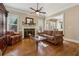 Bright living room boasts hardwood floors, fireplace, and neutral tones, creating a warm atmosphere at 11715 Dancliff Trce, Alpharetta, GA 30009
