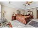 Cozy main bedroom featuring a tray ceiling, neutral walls, a decorative bedspread, and large bright windows at 11715 Dancliff Trce, Alpharetta, GA 30009