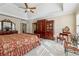 Bright main bedroom featuring neutral walls, a tray ceiling, a decorative bedspread, and an armoire at 11715 Dancliff Trce, Alpharetta, GA 30009