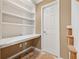 Office space featuring white built-ins with a desk and multiple shelves at 11715 Dancliff Trce, Alpharetta, GA 30009
