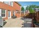 Brick patio with grilling area overlooks the fenced backyard at 11715 Dancliff Trce, Alpharetta, GA 30009