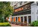 Charming outdoor restaurant seating area with bright orange umbrellas and lush greenery at 11715 Dancliff Trce, Alpharetta, GA 30009