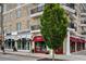 View of retail stores in a brick building with balconies and Magnolia Moon and Kilwins as tenants at 11715 Dancliff Trce, Alpharetta, GA 30009