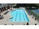 A large rectangular swimming pool with lounge chairs and tables in a well-maintained community area at 11715 Dancliff Trce, Alpharetta, GA 30009