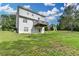 Spacious backyard with lush green lawn and a two-story home with a wooden deck perfect for enjoying the outdoors at 1405 Bramlett Forest Trl, Lawrenceville, GA 30045