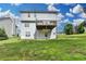 Home featuring a spacious backyard and a wooden deck, perfect for outdoor enjoyment and activities at 1405 Bramlett Forest Trl, Lawrenceville, GA 30045