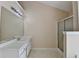Bathroom with a white vanity, large mirror, and a glass-enclosed shower at 1405 Bramlett Forest Trl, Lawrenceville, GA 30045