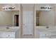 Bathroom features dual sinks, large mirrors, and classic fixtures at 1405 Bramlett Forest Trl, Lawrenceville, GA 30045