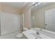 Full bathroom featuring a tub with shower, vanity, toilet and large mirror with modern lighting at 1405 Bramlett Forest Trl, Lawrenceville, GA 30045