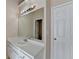 Bathroom vanity featuring a sink with chrome faucet, cabinets, a large mirror and modern lighting fixture at 1405 Bramlett Forest Trl, Lawrenceville, GA 30045