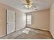 Cozy bedroom with plush carpet, neutral walls, and a ceiling fan with a light at 1405 Bramlett Forest Trl, Lawrenceville, GA 30045
