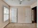 Bedroom with neutral colored walls and carpet, a window with blinds, and two white doors at 1405 Bramlett Forest Trl, Lawrenceville, GA 30045