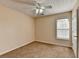 Cozy bedroom featuring neutral colored walls and carpet, a ceiling fan, and a window with blinds at 1405 Bramlett Forest Trl, Lawrenceville, GA 30045