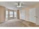 Bedroom featuring neutral colored walls and carpet and a charming window nook with three windows at 1405 Bramlett Forest Trl, Lawrenceville, GA 30045