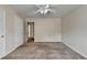 Bedroom with neutral colored walls and carpet features two white doors and a ceiling fan with lights at 1405 Bramlett Forest Trl, Lawrenceville, GA 30045