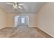 Spacious bedroom featuring neutral colored walls and carpet, a ceiling fan, and a charming window nook at 1405 Bramlett Forest Trl, Lawrenceville, GA 30045