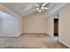 Spacious primary bedroom featuring a vaulted ceiling, fan, and neutral carpet at 1405 Bramlett Forest Trl, Lawrenceville, GA 30045