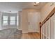 Inviting entryway features hardwood floors, staircase and view to the living room, with neutral paint throughout at 1405 Bramlett Forest Trl, Lawrenceville, GA 30045