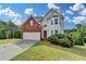 Charming two-story home features brick and vinyl siding with an attached two-car garage at 1405 Bramlett Forest Trl, Lawrenceville, GA 30045