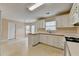 Well-maintained kitchen with white appliances, and an adjoining dining area with natural light at 1405 Bramlett Forest Trl, Lawrenceville, GA 30045