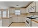 Bright kitchen has plenty of counter space, white appliances, and a gas range at 1405 Bramlett Forest Trl, Lawrenceville, GA 30045