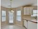 Eat-in kitchen featuring a door to the backyard and a window for ample natural light at 1405 Bramlett Forest Trl, Lawrenceville, GA 30045