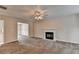 Bright living room featuring a fireplace, neutral carpet, and views to other areas of the home at 1405 Bramlett Forest Trl, Lawrenceville, GA 30045