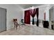 Living room featuring tile flooring, sofa, office chair, natural lighting and curtains at 1405 Bramlett Forest Trl, Lawrenceville, GA 30045