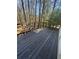 Rustic wooden deck with railing offers a private outdoor space surrounded by mature trees at 185 Windhaven Sw Trl, Atlanta, GA 30331