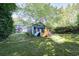 Expansive backyard with mature trees, playset, offering ample space for recreation at 2195 Edison Ne Ave, Atlanta, GA 30305