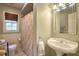 Traditional bathroom featuring a pedestal sink, tile floors, and decorative floral shower curtain at 2195 Edison Ne Ave, Atlanta, GA 30305
