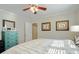 Bright bedroom with a ceiling fan, light grey walls, and a decorative teal dresser at 2195 Edison Ne Ave, Atlanta, GA 30305