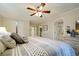 Spacious bedroom with a ceiling fan, closet, bathroom access, and stylish decor at 2195 Edison Ne Ave, Atlanta, GA 30305