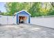 A detached blue garage with a white fence and driveway at 2195 Edison Ne Ave, Atlanta, GA 30305
