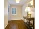 Hallway with hardwood floors, neutral walls, white trim, and a decorative table at 2195 Edison Ne Ave, Atlanta, GA 30305