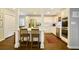 Bright kitchen with white cabinets, a center island, stainless steel appliances, and wood floors at 2195 Edison Ne Ave, Atlanta, GA 30305
